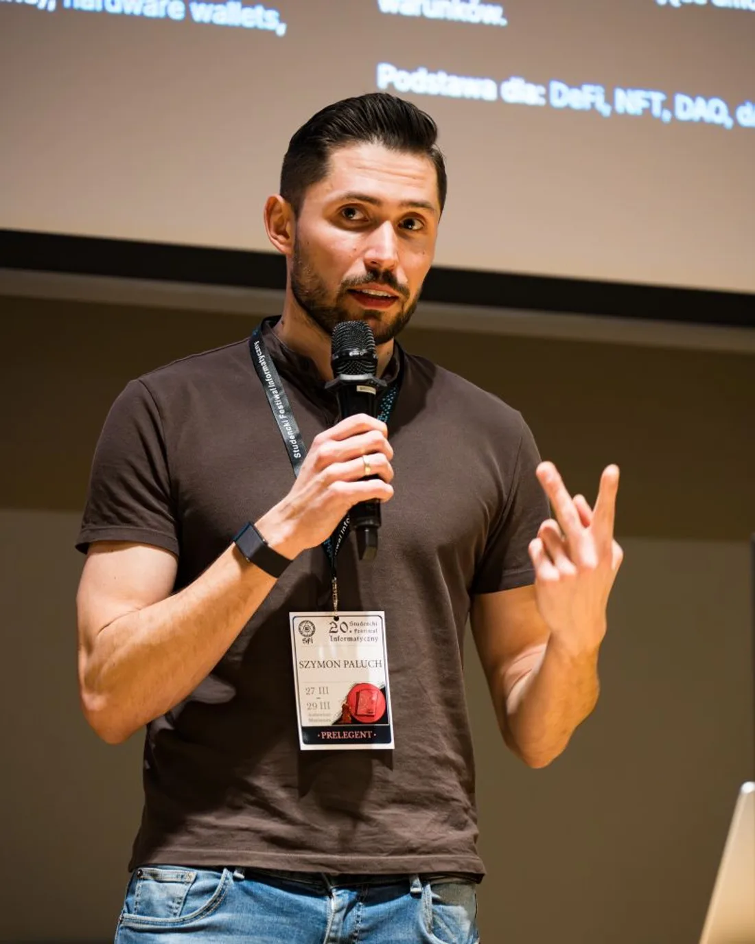 Szymon Paluch speaking on stage